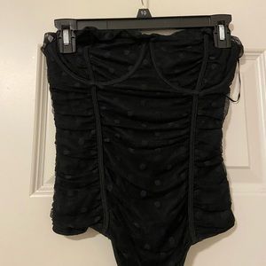 Black sleeveless polka dot bodysuit